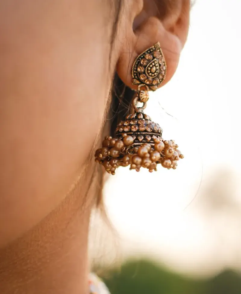 Temple jhumkas with a raw silk saree
